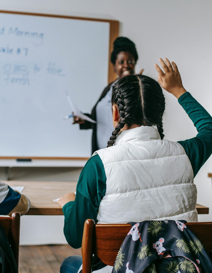 Black educator teaching finances to k12 students