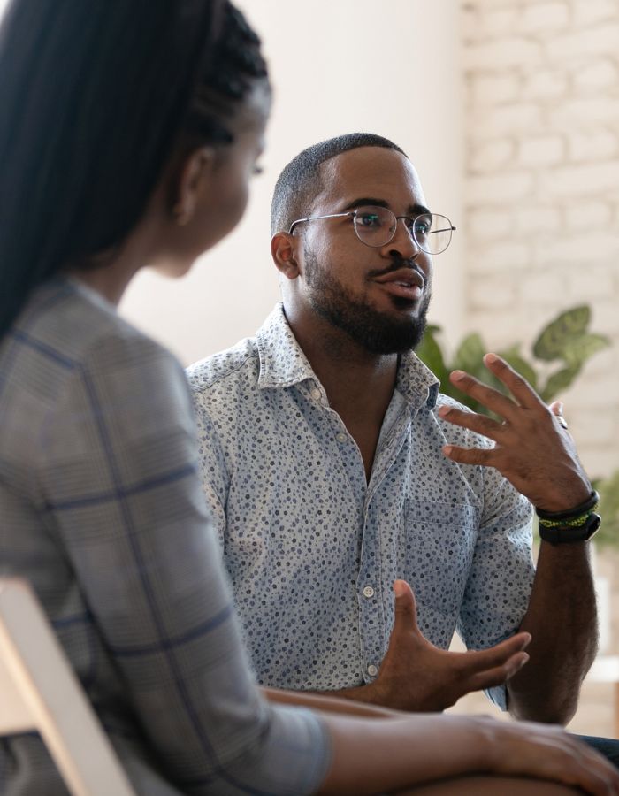 Black man wearing glasses teach small group