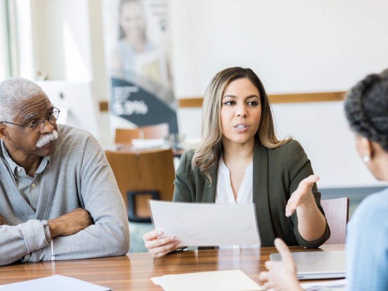 Financial advisor having conversation about retirement with older couple