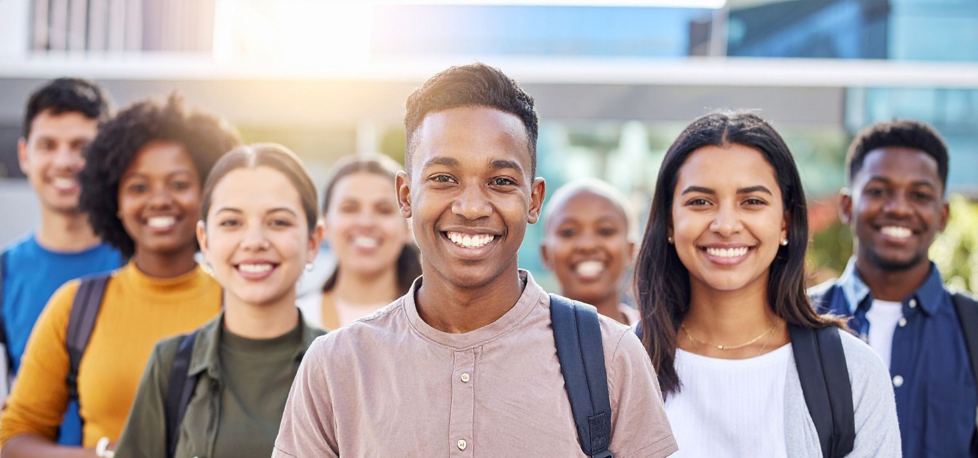 Group of eight college students looking forward and smiling