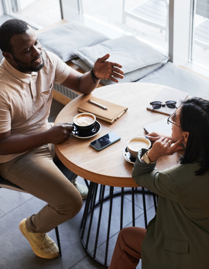 Man and woman having coffee and conversation