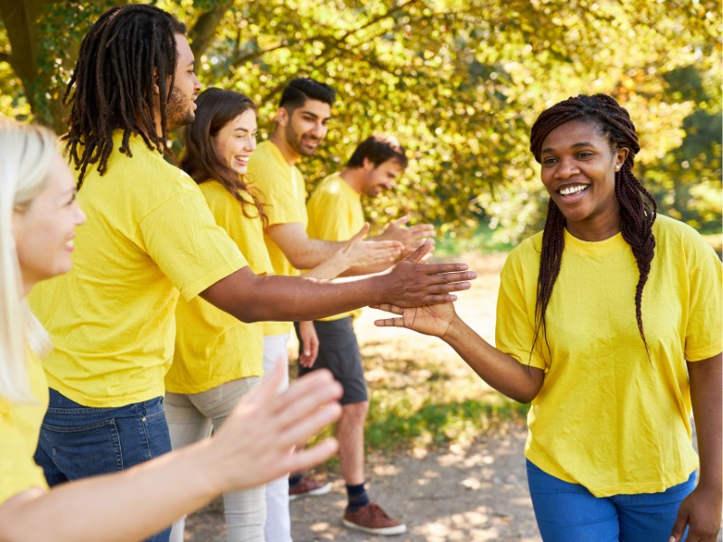 Young woman finishing race giving high fives